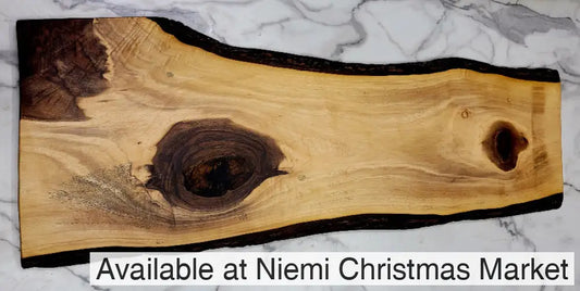 A Large irregularly shaped Live Edge Grazing Board with a light background and three interesting dark colour patches
